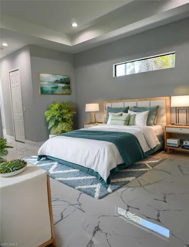 Bedroom featuring marble tiled floors, recessed lighting, baseboards, and a skylight