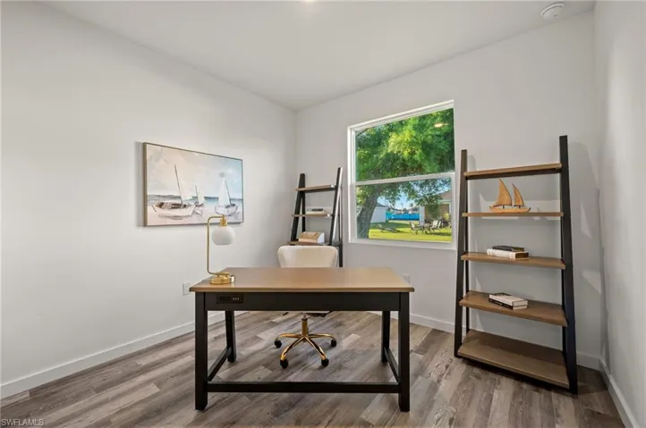 Home office with hardwood / wood-style floors