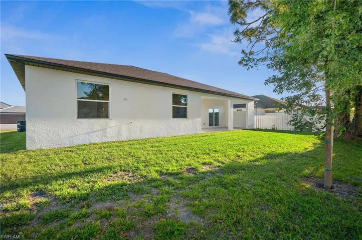 Rear view of house with a yard
