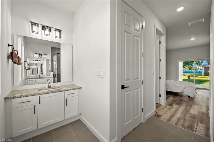 Bathroom featuring tile flooring and vanity
