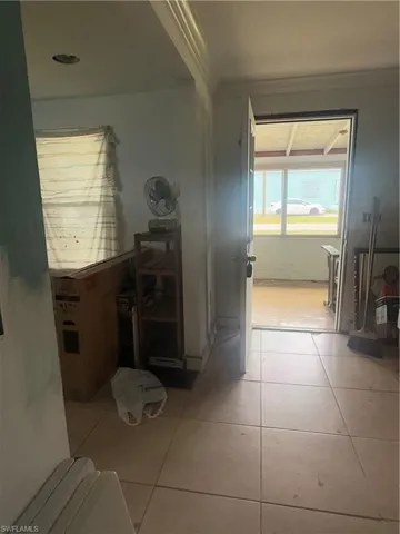 Hall featuring light tile patterned floors