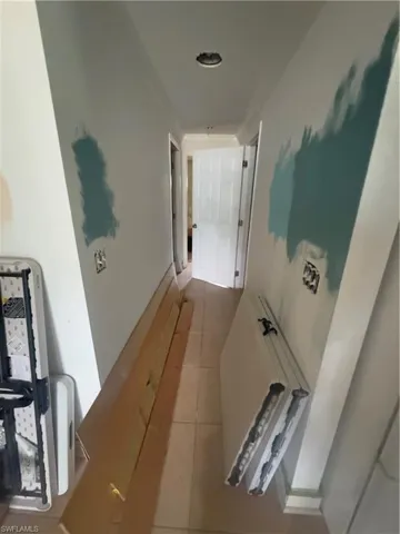 Corridor featuring tile patterned floors