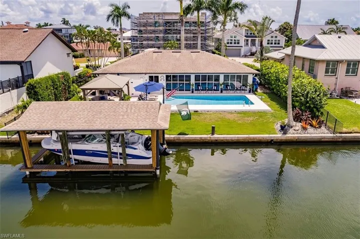 Dock area featuring a lawn, a patio, and a water view