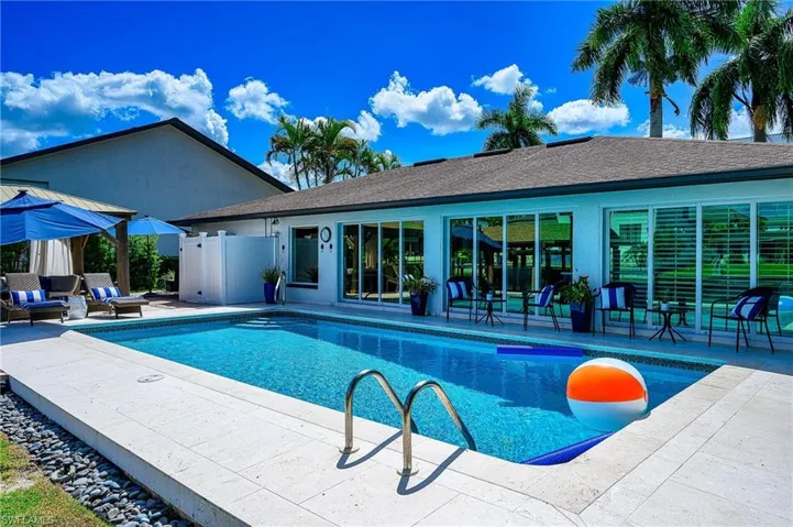 View of swimming pool with a patio and an outdoor living space