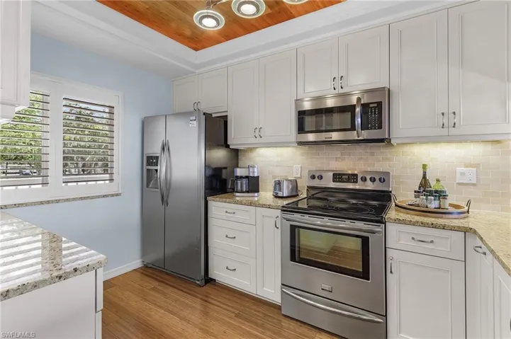 Plantation shutters, decorative wood ceiling, bamboo laminate flooring, stainless steel appliances, wood cabinets w/roll outs, granite counter tops, tile backsplash, stainless steel appliances. and under cabinet lighting.