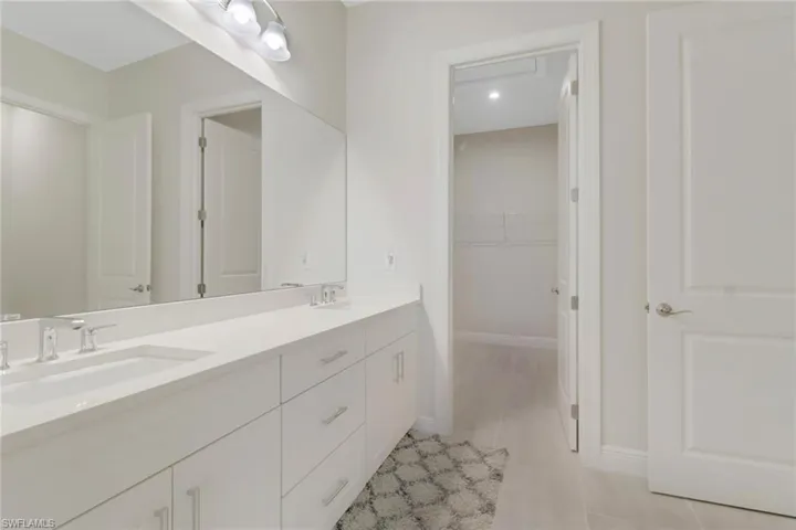 The master bath features dual sinks and a beautiful walk in shower.