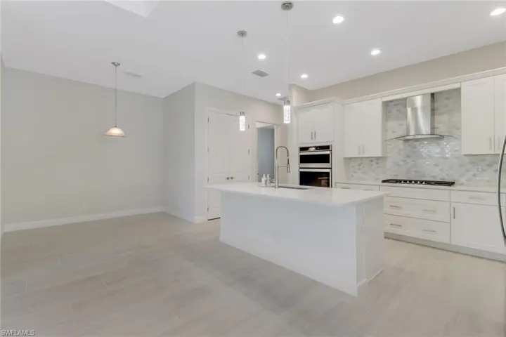 Beautiful chef's kitchen with upgraded appliances and quartz counters.
