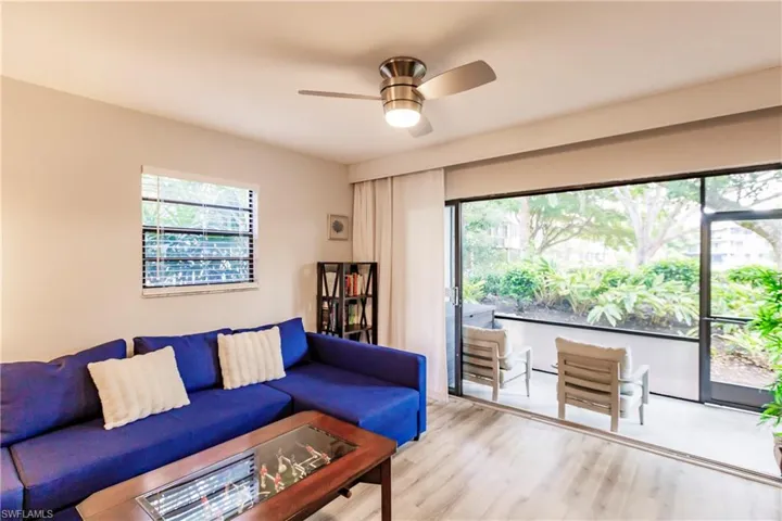 Living room with wood finished floors and ceiling fan