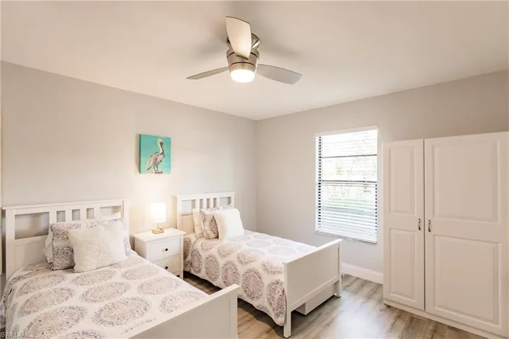 Bedroom with ceiling fan and light wood-style floors
