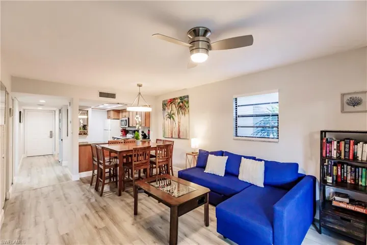 Living room with light wood-type flooring and ceiling fan