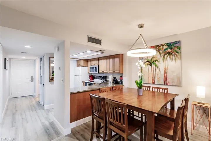 Dining space with light wood-type flooring and recessed lighting