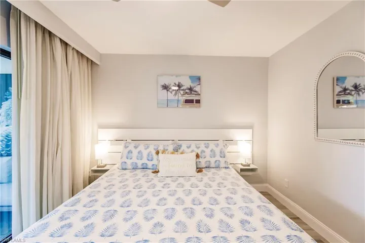 Bedroom with wood finished floors and access to outside