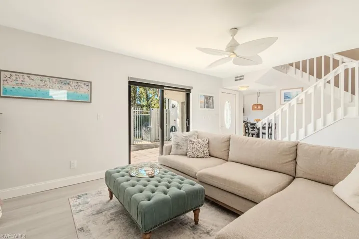 Living room featuring wood-type flooring and ceiling fan