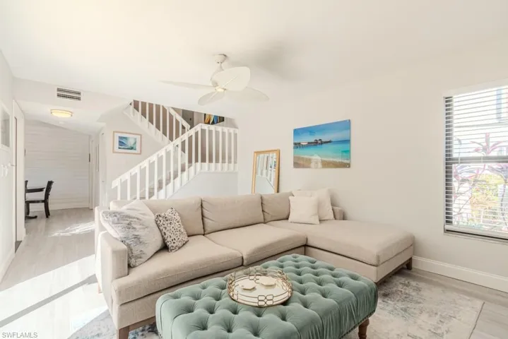 Living room featuring ceiling fan and wood-type flooring