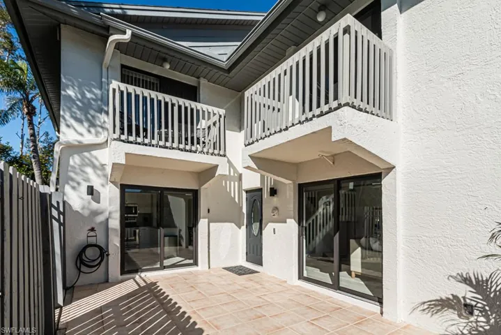 Back of property with a patio area and a balcony