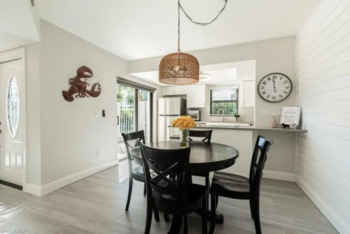 Dining room featuring sink, a healthy amount of sunlight, and light wood-type flooring