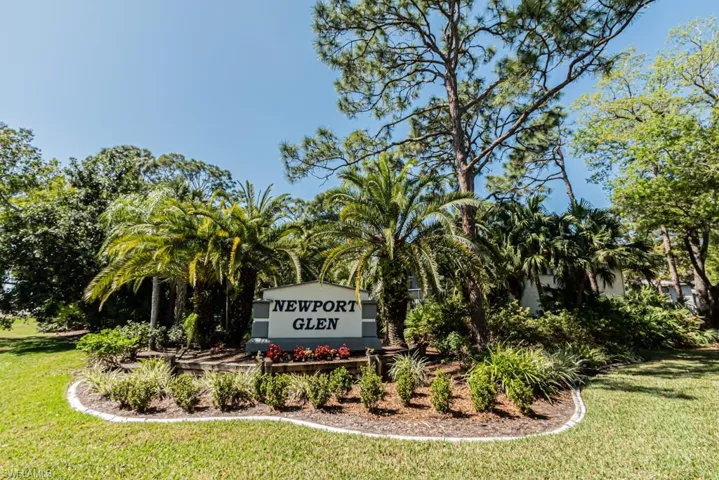 Community / neighborhood sign with a lawn