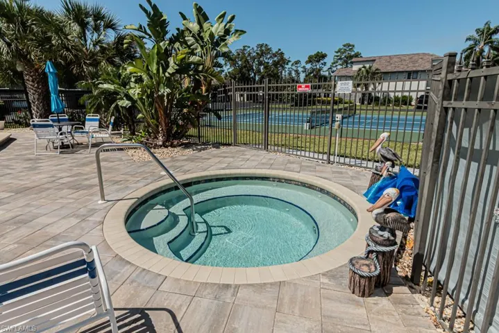 View of swimming pool featuring a community hot tub