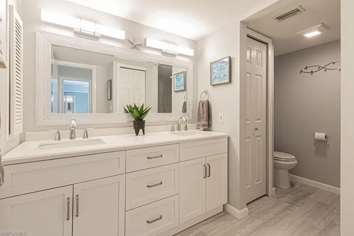 Bathroom featuring toilet, vanity, and hardwood / wood-style flooring