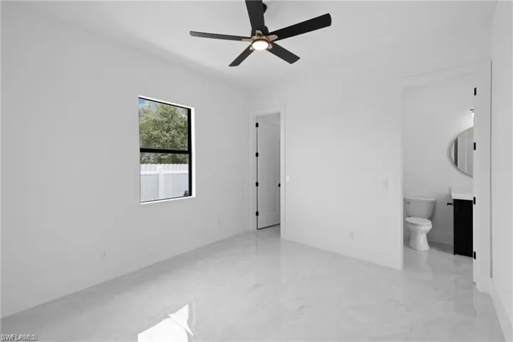 Unfurnished room featuring ceiling fan and light tile floors