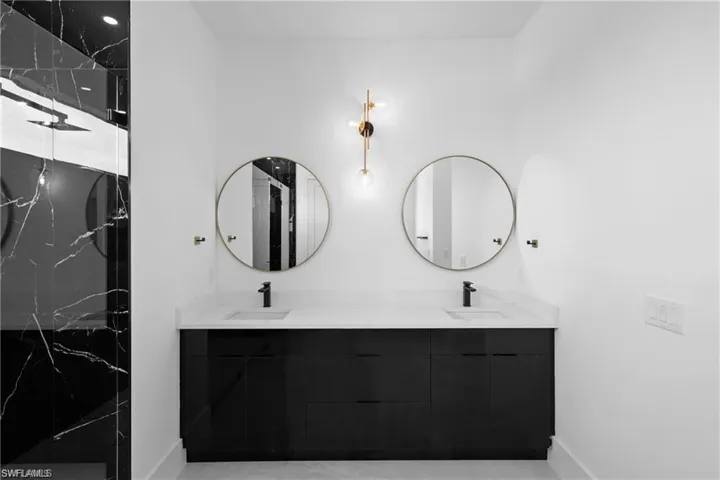 Bathroom with dual vanity and tile floors