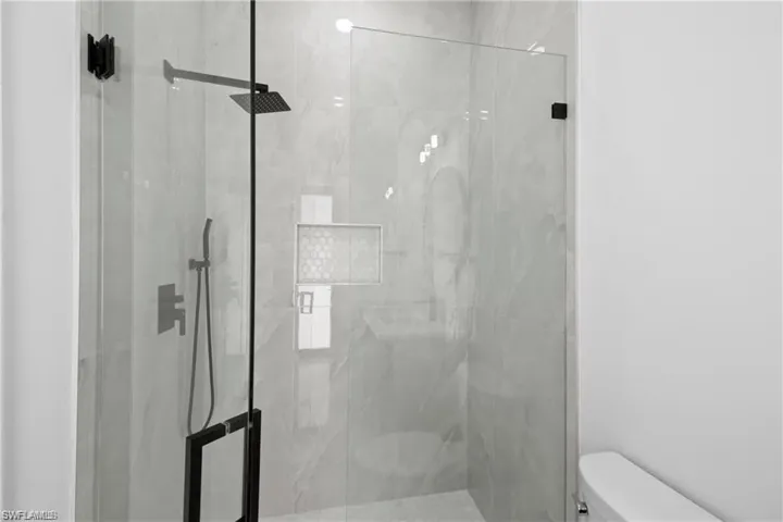 Bathroom featuring walk in shower and toilet