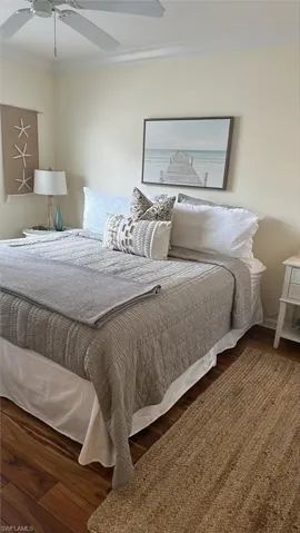Master bedroom with King size bed, molding, ceiling fan, and wood finished floors