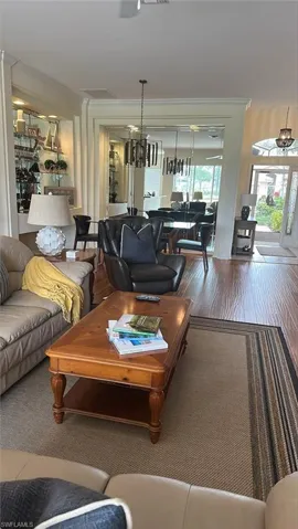 Living & dining area with beautiful Laminate flooring, huge mirror, glass front door.