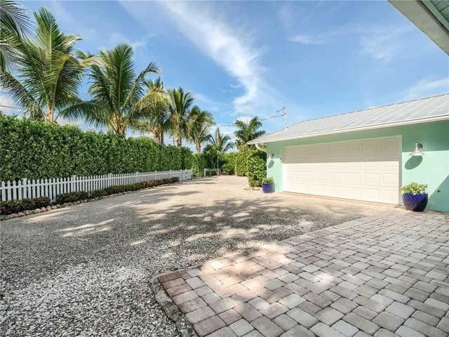 Front paver patio located behind privacy hedge