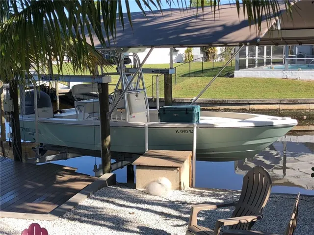 24' bay boat with stand-thru tower under the canopy. Canopy cover was replaced in 2023