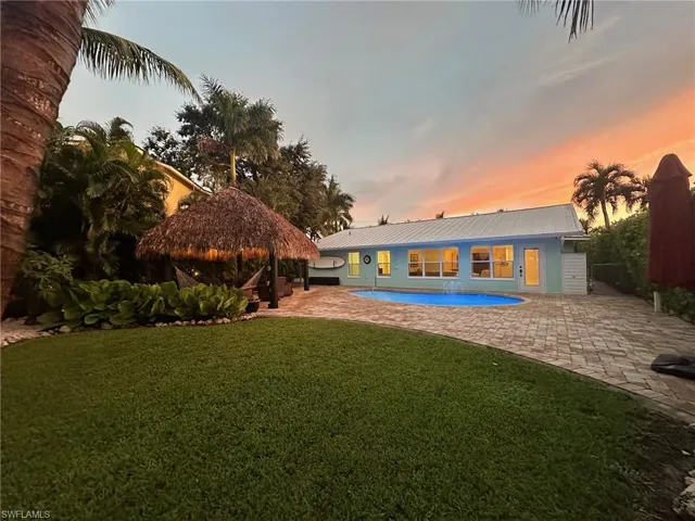 Enjoy the sunset in your backyard while lounging in the tiki and pool