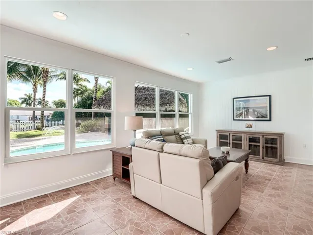 Rear facing living room focusing on the "tiki hut-island themed" experience that awaits you