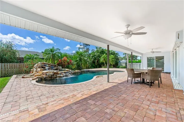 View of swimming pool with a fenced in pool, a fenced backyard, a patio area, outdoor dining space, and a ceiling fan