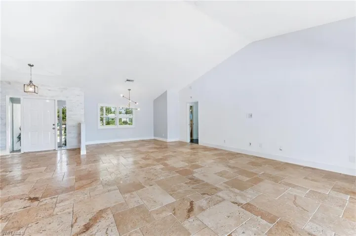 Living room looking to formal dining area with plantation shutters.