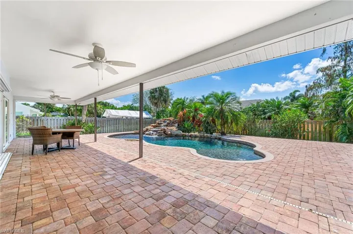 View of swimming pool featuring outdoor dining area, a ceiling fan, a patio, a fenced backyard, and a fenced in pool