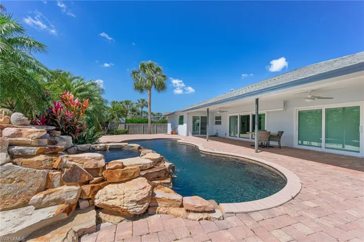 View of swimming pool featuring a ceiling fan, a patio area, fence, and a fenced in pool