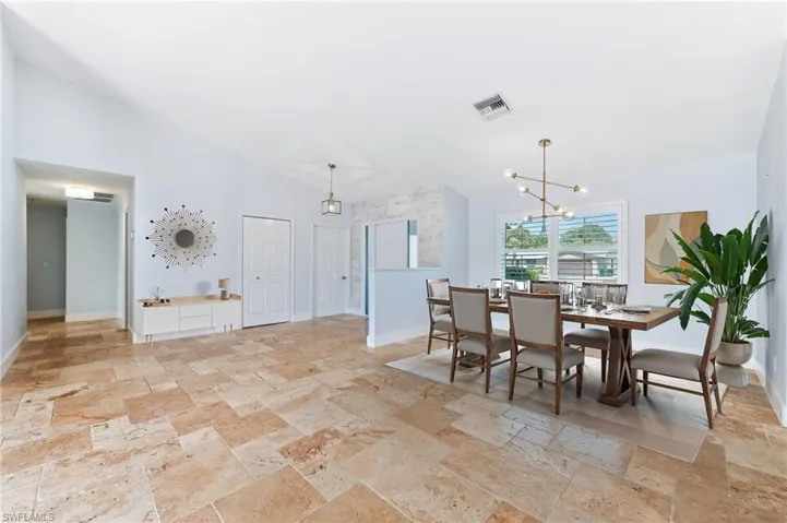 Virtually staged front foyer and dining room.