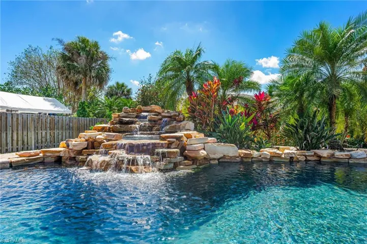 pool showing cascading water fall to hot tub and pool.