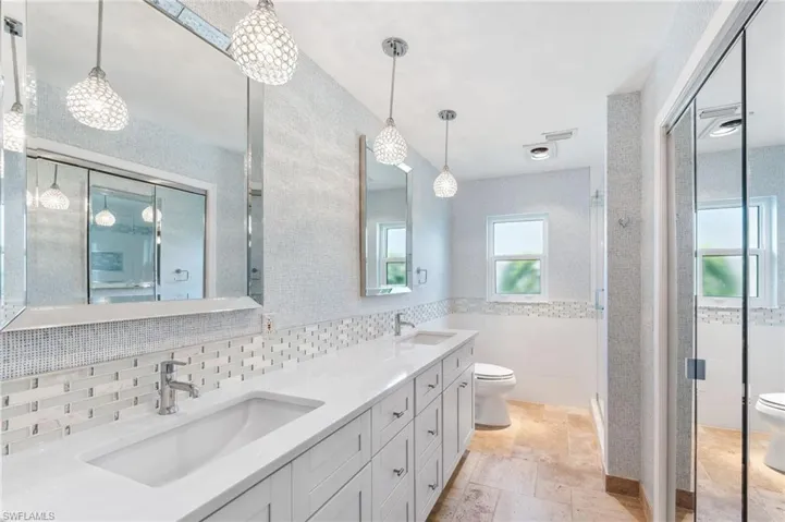 Main bathroom with dual sinks, soaking tub, and walk in shower.