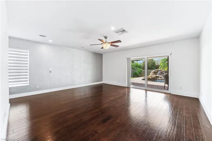 Extra large main bedroom with hardwood / wood-style flooring, a ceiling fan, visible vents, and baseboards