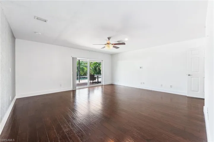 main bedroom with view to pool and oversized brick paver patio.