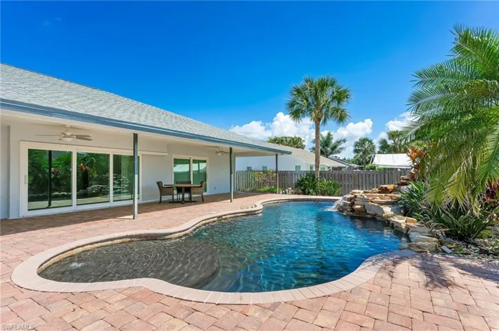 View of pool featuring a patio area, fence, a fenced in pool, and ceiling fan