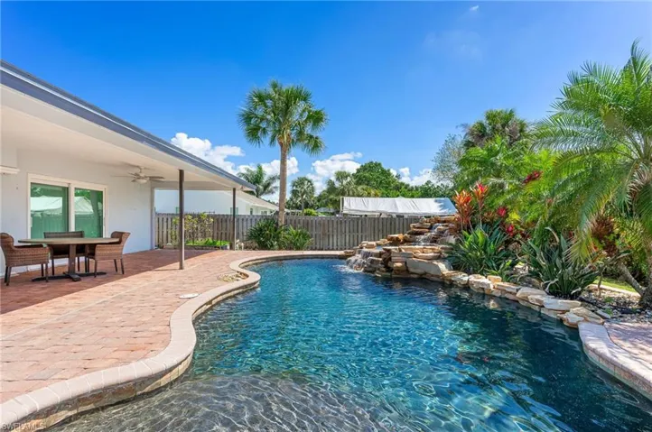 View of swimming pool with a ceiling fan, a patio area, fence, and a fenced in pool