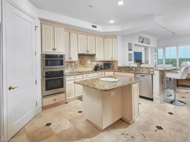 Gorgeous open kitchen with a large pantry and ample cabinetry.