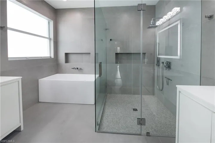 Fully renovated master bathroom with freestanding tub, walk-in shower and 2 vanities.