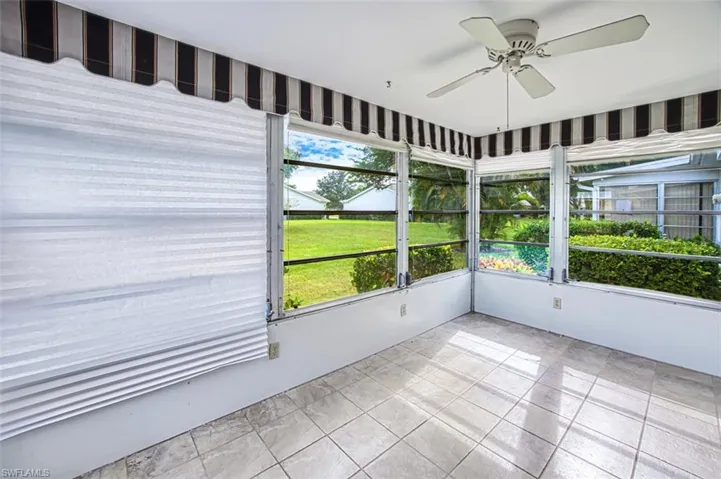 Unfurnished sunroom with a ceiling fan