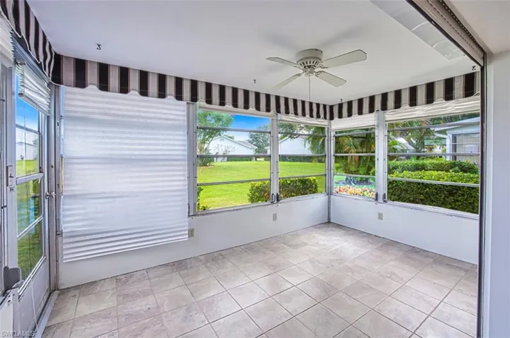 Unfurnished sunroom featuring ceiling fan and healthy amount of natural light