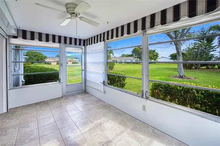 Unfurnished sunroom with ceiling fan