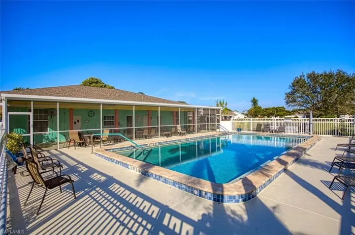 Community pool with a patio and a sunroom