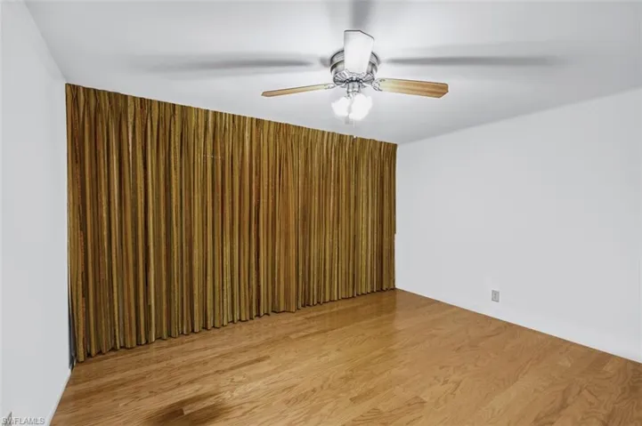 Spare room with light wood-style floors and a ceiling fan